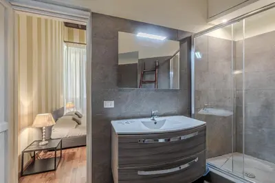 a bathroom with a sink and a shower at Appartamento Trevi Vicolo Scanderbeg in Rome
