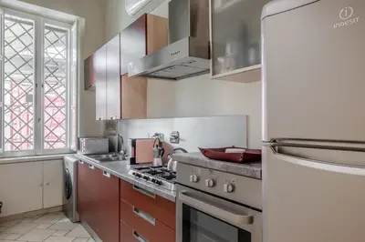 a kitchen with a stove and a refrigerator at Appartamento Trevi Vicolo Scanderbeg in Rome