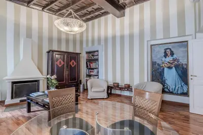 a living room with a painting of a woman at Appartamento Trevi Vicolo Scanderbeg in Rome
