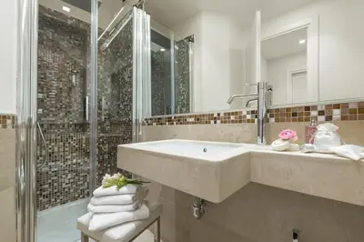 a bathroom with a large sink and a shower at Residenza Zanardelli in Rome