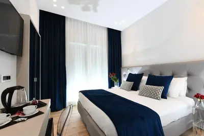 a hotel room with a large bed and a table at Residenza Zanardelli in Rome