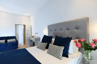 a bedroom with a blue and white bed with flowers on it at Residenza Zanardelli in Rome