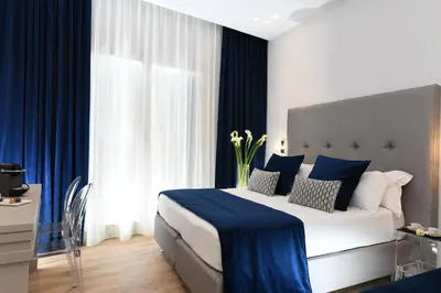 a bedroom with a large bed with blue and white at Residenza Zanardelli in Rome