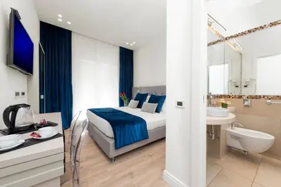 a hotel room with a bed and a sink and a bathroom at Residenza Zanardelli in Rome
