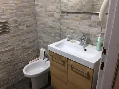 a bathroom with a sink and a toilet at Vacanze Romane 2 in Rome