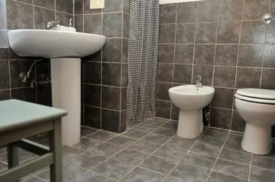 a bathroom with a sink and a toilet and a shower at Vacanze Romane 2 in Rome
