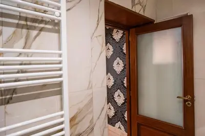 a door leading into a room with a window at Mario's apartament in the Spanish Steps in Rome