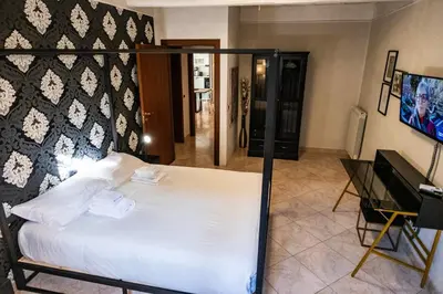 a bedroom with a white bed and a piano at Mario's apartament in the Spanish Steps in Rome
