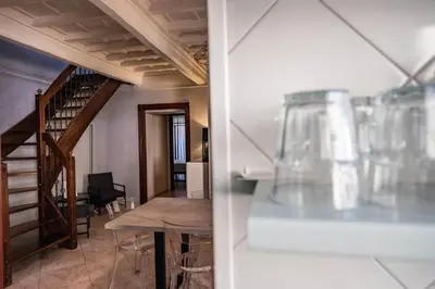 a dining room with a table and a staircase at Mario's apartament in the Spanish Steps in Rome