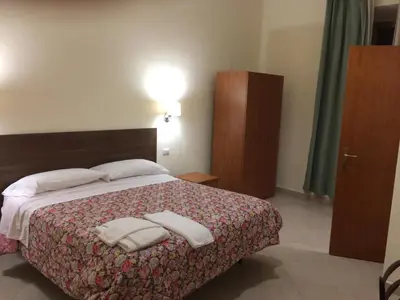 a bedroom with a bed with two towels on it at Albergo Enrica in Rome