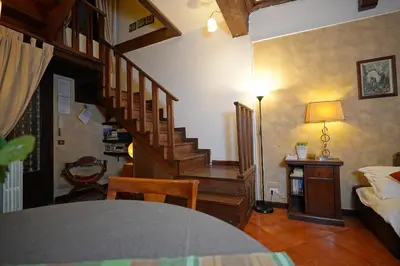 a living room with a staircase and a room with a bed at MGPgroup Rome Center Hot Spot in Rome