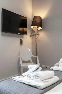 a room with a bed with a lamp and a chair at Trevi Luxury Terrace in Rome