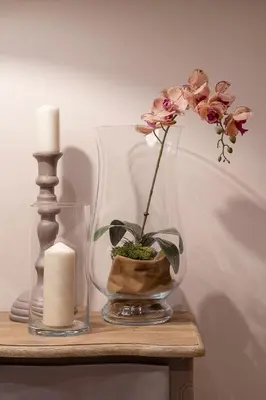a vase with a flower and a candle on a table at Trevi Luxury Terrace in Rome