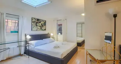 a bedroom with a bed and a glass table at My Cosy Home in Rome