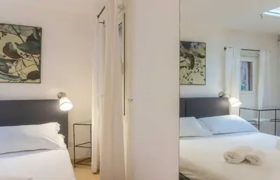 a bedroom with two beds and a mirror at My Cosy Home in Rome