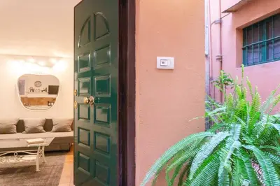 a green door in a room with a couch at My Cosy Home in Rome