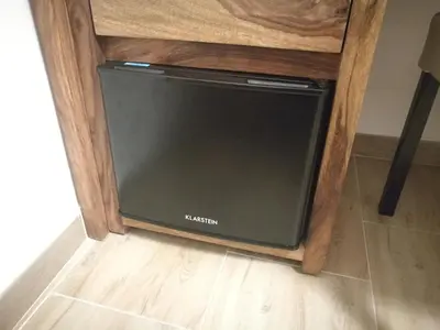 a dishwasher sitting in a wooden cabinet at Al Trenino accomodation in Rome