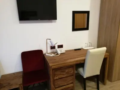 a room with a desk with a phone and two chairs at Al Trenino accomodation in Rome