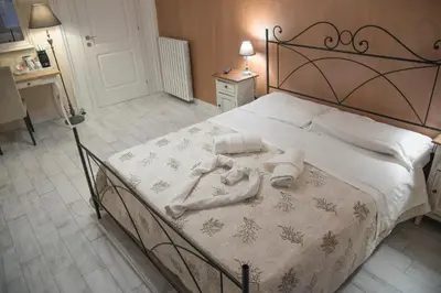 a bedroom with a large bed with towels on it at Baldassini Suites in Rome