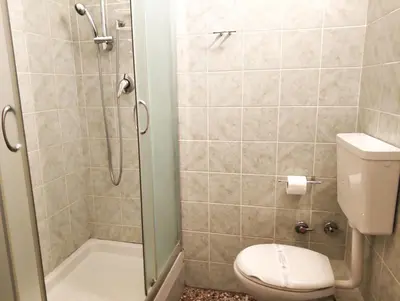 a bathroom with a toilet and a shower at Baldassini Suites in Rome