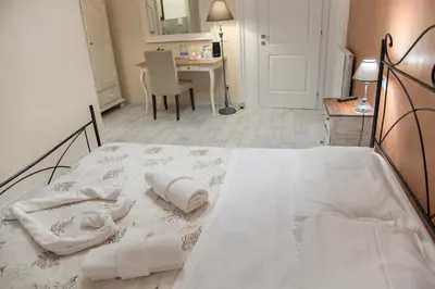 a bedroom with a bed with towels on it at Baldassini Suites in Rome