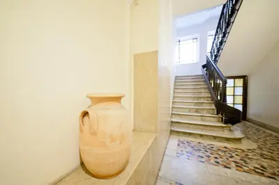 a large vase sitting on a wall next to a staircase at Baldassini Suites in Rome