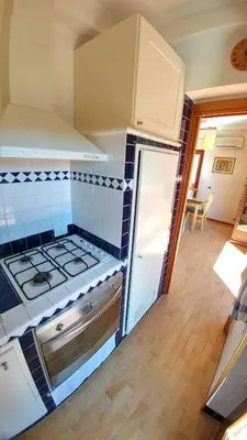a kitchen with a stove top oven in a room at Terrace22 - Delizioso attico ben collegato in Rome