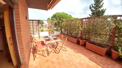 a patio with a table and chairs on a balcony at Terrace22 - Delizioso attico ben collegato in Rome