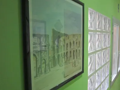 a kitchen with a white desk and a tv on the wall at Evergreen in Rome