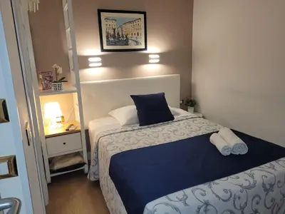 a bedroom with a bed and a desk and a mirror at Evergreen in Rome