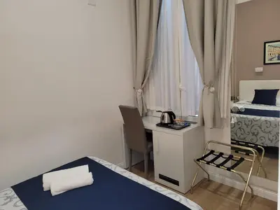 a bedroom with a bed with towels on it at Evergreen in Rome