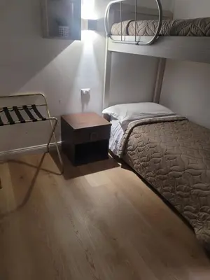 a room with two bunk beds and a desk with a desk at Evergreen in Rome