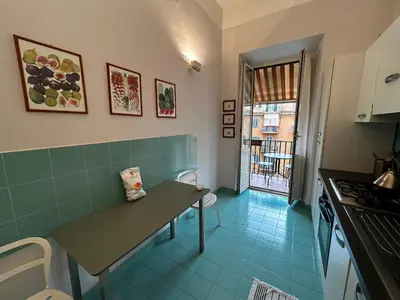 a small kitchen with a table and a window at Vatican Attic in Rome