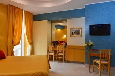 a hotel room with a bed and a dining room at Fabio dei Velapazza Guesthouse in Rome