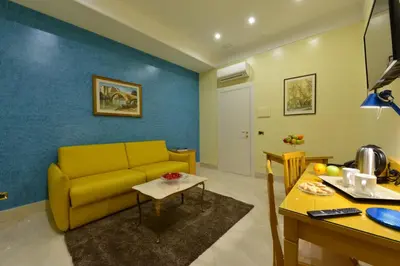 a living room with a yellow couch and a table at Fabio dei Velapazza Guesthouse in Rome