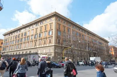 a group of people walking in front of a large building at Quo Vadis Roma 2 in Rome