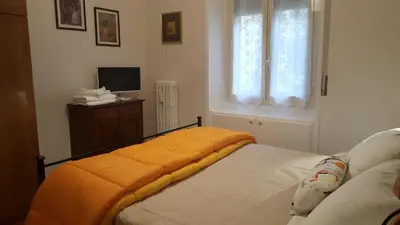 a bedroom with a bed with an orange blanket on it at homedieci in Rome