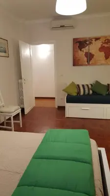 a bedroom with a bed with a green blanket on it at homedieci in Rome