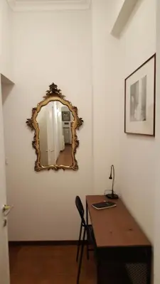 a room with a desk and a mirror on the wall at homedieci in Rome