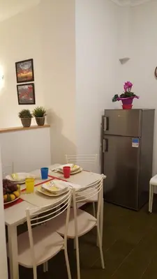 a kitchen with a table and a refrigerator at homedieci in Rome