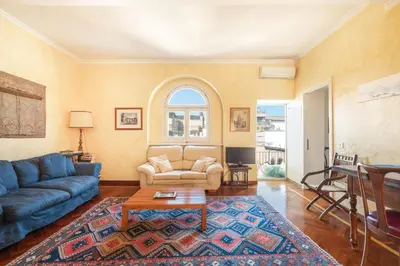 a living room with a blue couch and a table at Trevi Comfortable Apartment with Terrace | Romeloft in Rome