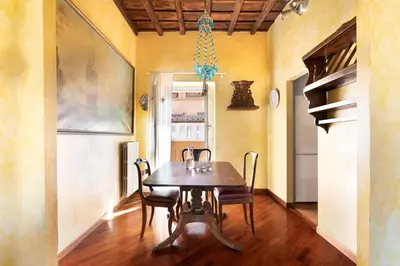 a dining room with a wooden table and chairs at Trevi Comfortable Apartment with Terrace | Romeloft in Rome