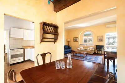 a kitchen and living room with a table and chairs at Trevi Comfortable Apartment with Terrace | Romeloft in Rome