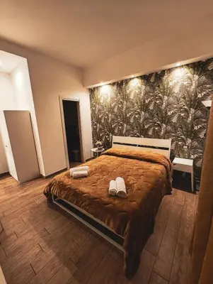 a bedroom with a large bed with shoes on it at MVM Apartment in Rome