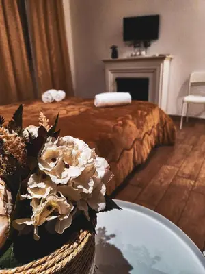 a bedroom with a bed and a table with flowers at MVM Apartment in Rome