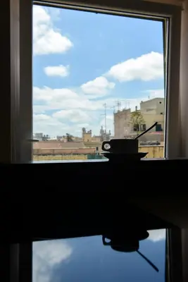 a window with a view of a city at At Home Townhouse - Filiberto in Rome