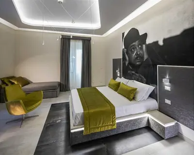 a bedroom with a bed with a painting of a cowboy at Via Veneto Luxury Suites in Rome