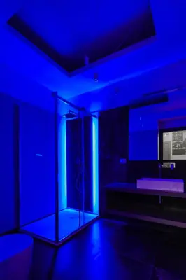 a blue room with a shower with a blue light at Via Veneto Luxury Suites in Rome