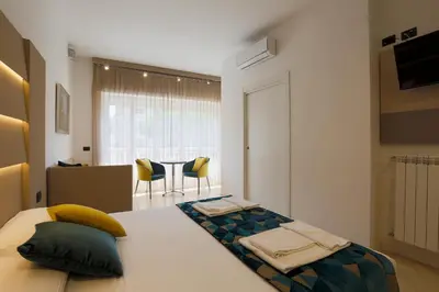 a bedroom with a bed and two chairs at DaVinci Relais Guest House in Rome