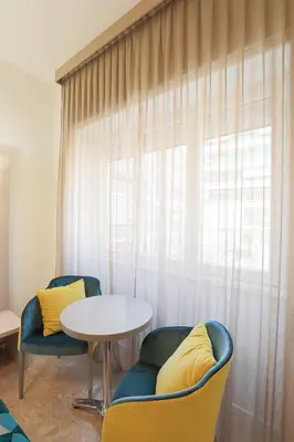 a room with two chairs and a table and a window at DaVinci Relais Guest House in Rome